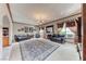 Spacious living room with dark sofas, fireplace, chandelier and decorative rug at 241 E Country Club Dr, Henderson, NV 89015
