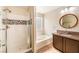 Modern bathroom with shower, glass-block window, and soaking tub at 2653 Rimbaud St, Henderson, NV 89044