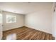 Bright bedroom features hardwood floors, a large window and neutral paint at 2653 Rimbaud St, Henderson, NV 89044