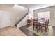Dining room with a wood table, rug, dark wood laminate flooring, and staircase at 2653 Rimbaud St, Henderson, NV 89044