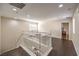Bright landing area with white banister and dark wood-look floors at 2653 Rimbaud St, Henderson, NV 89044