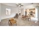 Open-concept living area with tile flooring, large windows, and seamless flow into the kitchen at 2653 Rimbaud St, Henderson, NV 89044