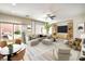 Open living room area with modern furnishings, sliding glass doors to backyard, and ample natural light at 2653 Rimbaud St, Henderson, NV 89044