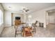 Open concept living room area with tiled floors, ceiling fan, and a window offering natural light at 2653 Rimbaud St, Henderson, NV 89044