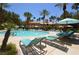 Luxurious pool area with many lounge chairs, palm trees and sun umbrellas for outdoor relaxation and enjoyment at 270 E Flamingo Rd # 319, Las Vegas, NV 89169