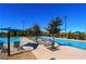 Inviting community pool featuring ample seating and shade structures at 2880 Starling Summit St, Henderson, NV 89044