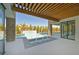 Backyard with a covered patio, pool, fountain feature, and lush greenery at 34 Vintage Canyon St, Las Vegas, NV 89141