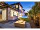 Backyard with stone pavers and a cozy outdoor fire pit, lush lawn and grilling area at 34 Vintage Canyon St, Las Vegas, NV 89141