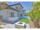 Backyard view of home showcasing a pool, outdoor kitchen, fire pit, and patio area, perfect for entertaining at 34 Vintage Canyon St, Las Vegas, NV 89141