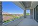 Balcony with stone columns, railing, and scenic views of the surrounding neighborhood and mountains at 34 Vintage Canyon St, Las Vegas, NV 89141