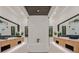 Modern bathroom featuring dual vanities, a soaking tub and a glass enclosed shower at 34 Vintage Canyon St, Las Vegas, NV 89141