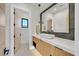 Stylish bathroom with a modern vessel sink, unique lighting fixtures, and sleek wood-look cabinetry at 34 Vintage Canyon St, Las Vegas, NV 89141