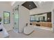 Luxurious bathroom featuring a soaking tub, modern vanity, and sleek glass-enclosed shower at 34 Vintage Canyon St, Las Vegas, NV 89141