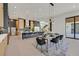 Open concept dining area adjacent to kitchen, features seating for eight and modern light fixtures at 34 Vintage Canyon St, Las Vegas, NV 89141