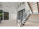 The foyer features a modern staircase and glass enclosed wine cellar at 34 Vintage Canyon St, Las Vegas, NV 89141