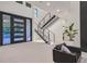 Bright foyer boasts a modern staircase with glass railings and sleek tile flooring at 34 Vintage Canyon St, Las Vegas, NV 89141