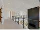 Hallway with a metal railing staircase and a modern fireplace feature wall at 34 Vintage Canyon St, Las Vegas, NV 89141