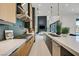 Sleek kitchen featuring stainless steel appliances, an island with a sink, and a view into the living room at 34 Vintage Canyon St, Las Vegas, NV 89141