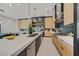 Modern kitchen featuring an island, stainless steel appliances, sleek countertops and cabinetry, and pendant lighting at 34 Vintage Canyon St, Las Vegas, NV 89141
