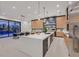 Gourmet kitchen boasts modern appliances, a large island with bar seating, and adjacent dining area at 34 Vintage Canyon St, Las Vegas, NV 89141