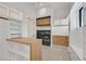 Spacious laundry room with modern washer and dryer, custom cabinets, and ample storage space at 34 Vintage Canyon St, Las Vegas, NV 89141