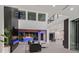 Expansive living area with sleek fireplace overlooks a covered outdoor patio and pool at 34 Vintage Canyon St, Las Vegas, NV 89141