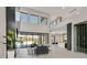 Bright living room with a modern fireplace, high ceilings, and sliding glass doors to the outdoor pool area at 34 Vintage Canyon St, Las Vegas, NV 89141