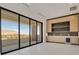 Bright living room featuring a balcony with neighborhood views and custom cabinetry with beverage fridge at 34 Vintage Canyon St, Las Vegas, NV 89141