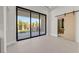 Bright living room with sliding glass doors and backyard access with outdoor kitchen at 34 Vintage Canyon St, Las Vegas, NV 89141