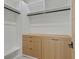 A spacious walk-in closet with custom shelving, cabinets and drawers at 34 Vintage Canyon St, Las Vegas, NV 89141