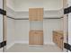 Bright walk-in closet with custom cabinetry, shelving, and hanging rods for organized storage at 34 Vintage Canyon St, Las Vegas, NV 89141