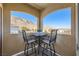 Cozy balcony with a small table, chairs, and a view of the mountains at 3574 Desert Cliff St # 204, Las Vegas, NV 89129