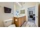 Bright bathroom with double sinks, large mirror, and view into the bedroom at 3574 Desert Cliff St # 204, Las Vegas, NV 89129