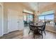 Dining area features wood table, sliding door to balcony and picturesque window at 3574 Desert Cliff St # 204, Las Vegas, NV 89129