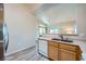Bright kitchen with gray wood-look flooring and view into the dining area at 3574 Desert Cliff St # 204, Las Vegas, NV 89129