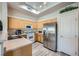 Bright kitchen features stainless steel appliances, wood cabinets, and gray wood-look flooring at 3574 Desert Cliff St # 204, Las Vegas, NV 89129