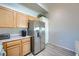 Spacious kitchen features stainless steel refrigerator and wood cabinets at 3574 Desert Cliff St # 204, Las Vegas, NV 89129