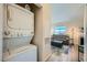 Living room view featuring a laundry closet, fireplace, sofa, and a view at 3574 Desert Cliff St # 204, Las Vegas, NV 89129
