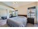 Large bedroom with two large windows, ceiling fan, and mirrored closet at 3574 Desert Cliff St # 204, Las Vegas, NV 89129