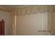 Bedroom with light-filtering vertical blinds and floral valance at 3805 Vidalia Ave, North Las Vegas, NV 89031