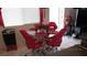 Dining area featuring a glass-topped table, red chairs and a window view at 3805 Vidalia Ave, North Las Vegas, NV 89031