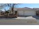 Charming single-story home featuring a terracotta tile roof, two-car garage, and a well-maintained front yard at 3805 Vidalia Ave, North Las Vegas, NV 89031