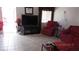 Living room featuring a large television and red seating, and a window view at 3805 Vidalia Ave, North Las Vegas, NV 89031