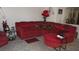 Cozy living room with plush red sectional sofa and decorative pillows at 3805 Vidalia Ave, North Las Vegas, NV 89031