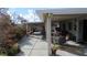 Beautiful outdoor patio with dining set, lounge chair, and lush landscaping at 3805 Vidalia Ave, North Las Vegas, NV 89031