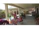 Expansive covered patio with lounge chair, rocking chair and manicured garden, perfect for relaxing at 3805 Vidalia Ave, North Las Vegas, NV 89031