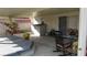 Cozy covered patio featuring a hot tub, rocking chair, and vibrant flower arrangements for outdoor relaxation at 3805 Vidalia Ave, North Las Vegas, NV 89031