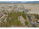 Aerial perspective of a home with adjacent trees, situated in a rural neighborhood with mountains in the distance at 4021 Jesse St, Pahrump, NV 89048