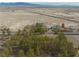 Overhead view of a charming home nestled among mature trees with desert landscape in the background at 4021 Jesse St, Pahrump, NV 89048