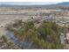 From above, a home is partially concealed by trees, complemented by rural scenery, streets, and desert mountain range at 4021 Jesse St, Pahrump, NV 89048